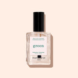 A clear glass bottle of Manucurist Vitaminized Base Coat Green™ with a black cap, photographed on a light beige background. Powered by KeraHCE+ technology, this base coat strengthens nails and creates the ideal foundation for your manicure.