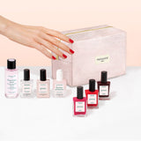 The Manucurist Starter Kit features plant-based nail polishes, nail care essentials, and a pale pink manicure bag labeled “manucurist PARIS,” all elegantly arranged on a light background for a sophisticated green manicure experience.
