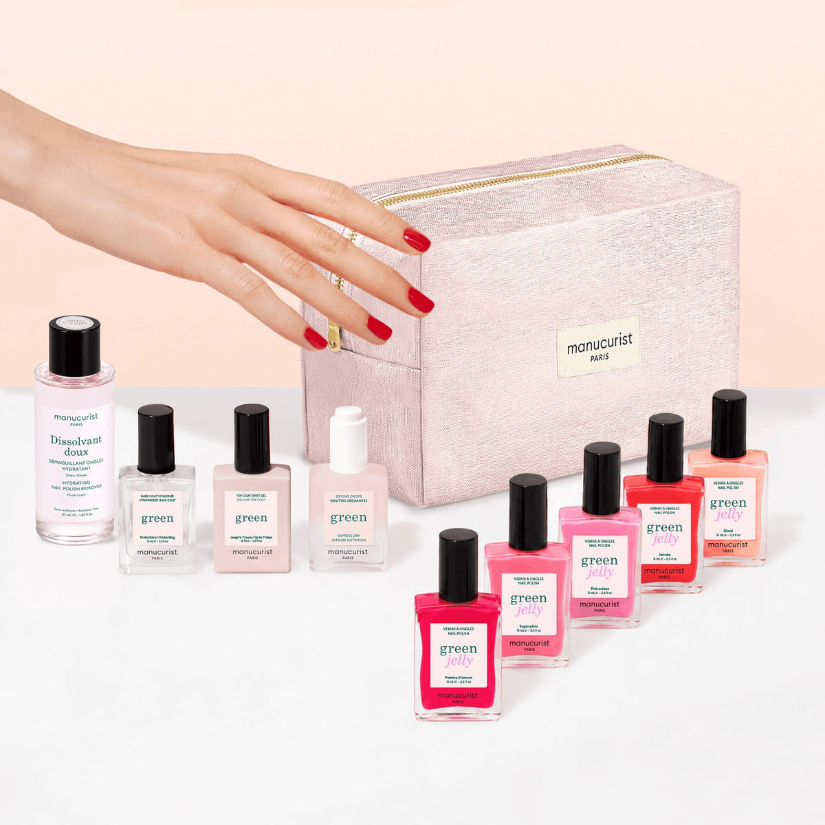 A pink cosmetic bag featuring the Manucurist logo is displayed above the Super Starter Kit - Jelly Nail Polish by Manucurist. The kit includes nine nail care products—colorful gel effect polishes crafted with plant-based ingredients, a remover, a serum, and a top coat—all neatly arranged on a beige background.