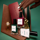 Three horizontal sections display close-ups of Manucurist Green Flash gel polishes from the Customizable Trio: a deep red shade labeled Amour, a dark green labeled Emerald, and a shimmery white labeled Bliss. Each section showcases a streak of glossy Green Flash gel polish, highlighting vibrant color payoff and shine—all easily removed with your favorite nail polish remover.