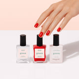 The Manucurist Basic Kit is shown with three bottles side by side on a light beige background. Ideal for gel-effect manicures, the set features a base coat, bright red polish, and top coat—all with sleek black caps.