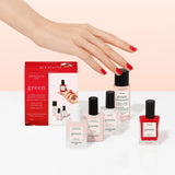 Manucurist’s Discovery Kit features five Green manicure products—including gel-effect, plant-based nail polish, base coat, top coat, remover, and a treatment—arranged on a light peach background.
