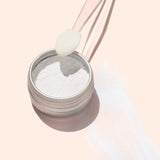A round metal tin of Manucurist Blue Glazed Powder, a fine white manicure powder, viewed from above on a light beige background.