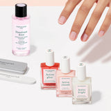 The Manucurist Active Manicure Kit features two nail files, three bottles of nail treatment polish, and a bottle of nail polish remover—each item neatly arranged on a light beige background, making it the perfect addition to any manicure kit.