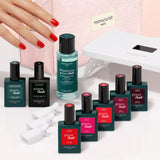 The Manucurist Super Starter Kit, arranged neatly on a light background, includes a pink pouch, UV lamp, nail polish remover, four polishes with white caps, plus two top/base coats—providing everything you need for an ultra-glossy manicure at home.