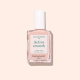 A bottle of Manucurist Active™ Smooth 00 nail treatment, topped with a white cap, sits on a light pink background. The white label features green and black text, highlighting the brand’s dedication to plant-based nails.