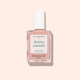 A bottle of Manucurist Active™ Smooth 01 nail care polish with a white cap is displayed against a pale peach background, showcasing this plant-based CC Polish Treatment formulated to perfect and protect your nails.