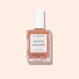 A bottle of Manucurist Active™ Smooth 02 nail care polish with a white cap, displayed against a pale peach background. The white label with green and black text emphasizes this advanced CC Polish as an ideal treatment for healthier-looking nails.